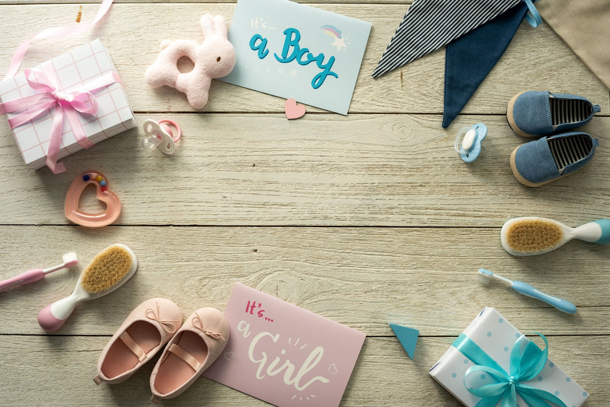 Baby gifts and accessories laid out together for a new baby