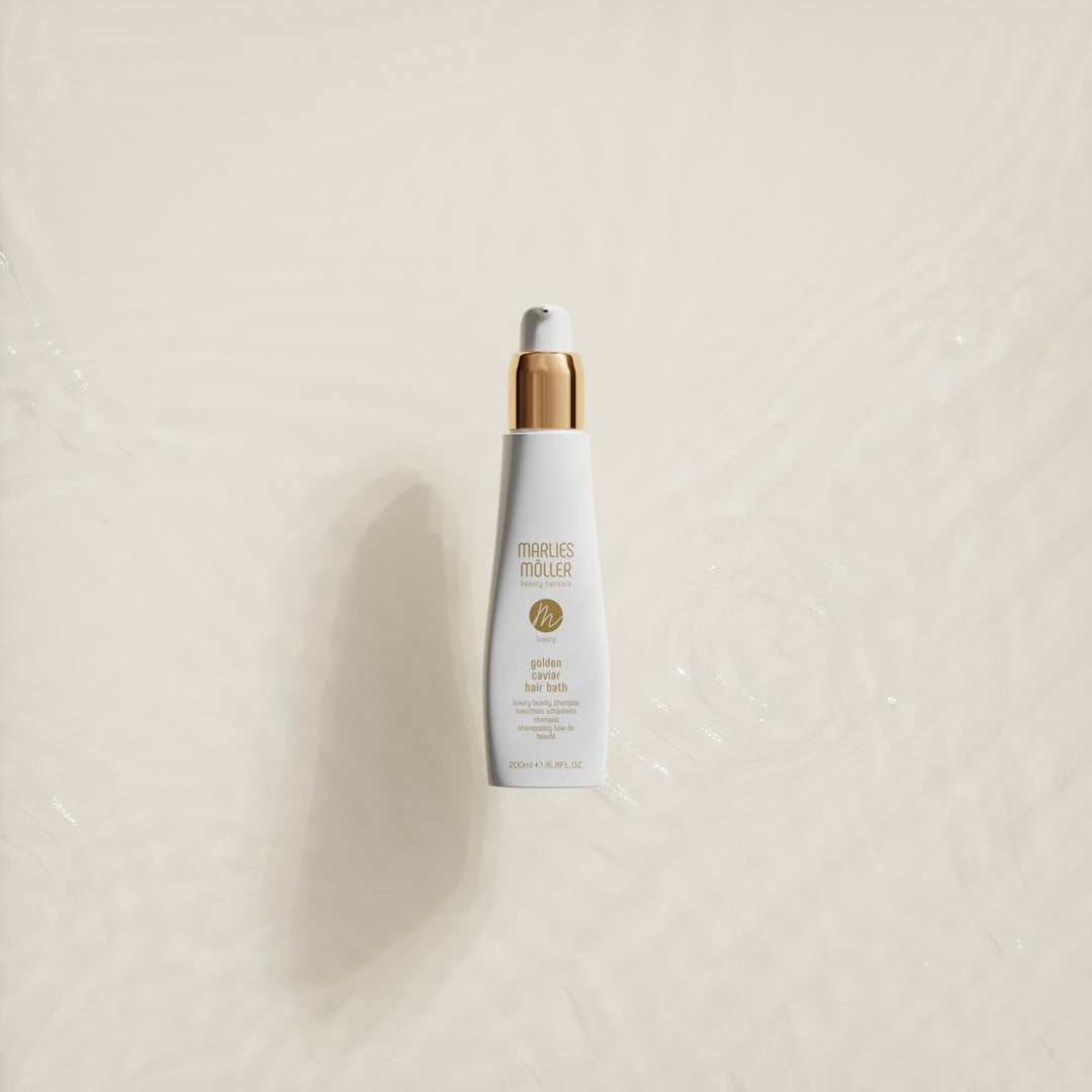200 ml pump bottle of Golden Caviar Repair Hair Bath, amber-hued shampoo