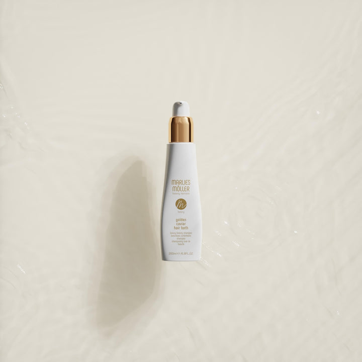 200 ml pump bottle of Golden Caviar Repair Hair Bath, amber-hued shampoo