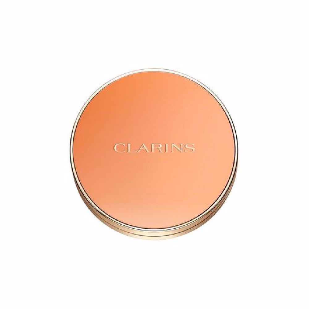 Clarins Round orange compact powder case with metallic rim, embossed brand name, minimalist metal/plastic finish