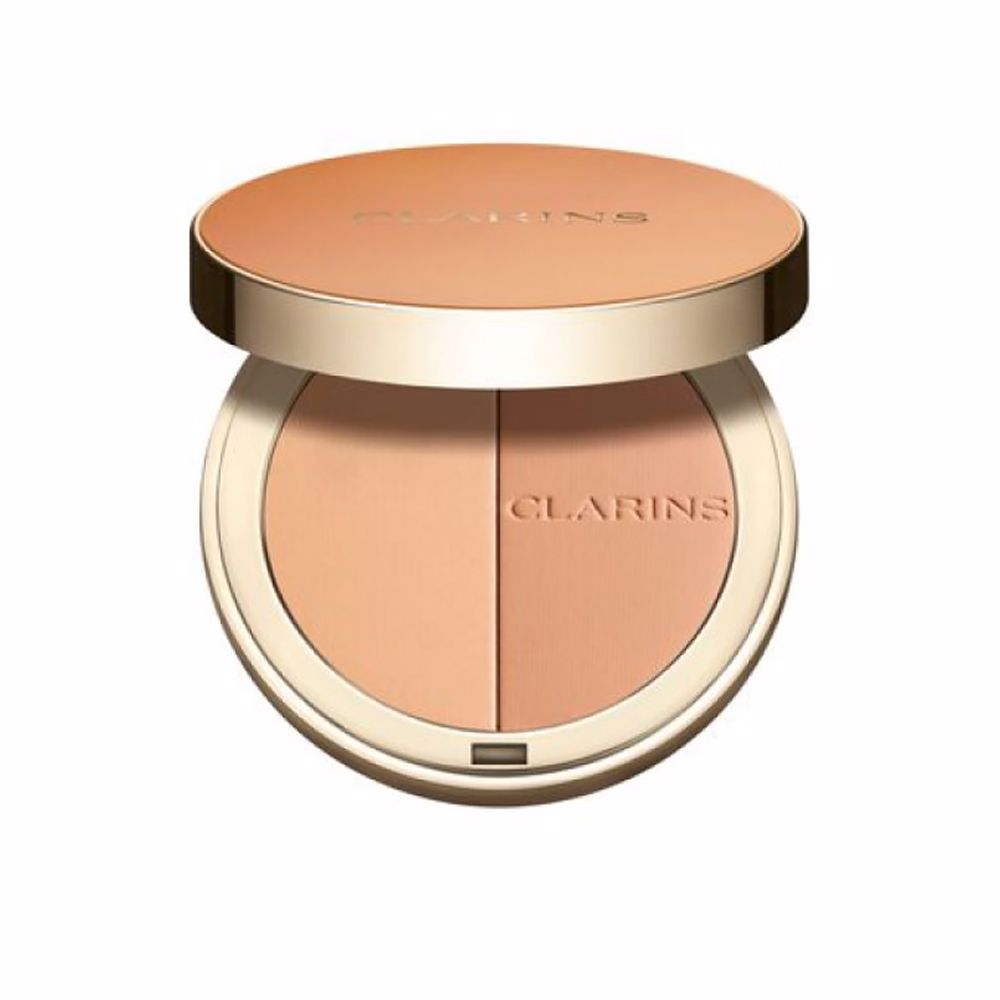 Clarins Round orange compact powder case with metallic rim, embossed brand name, minimalist metal/plastic finish