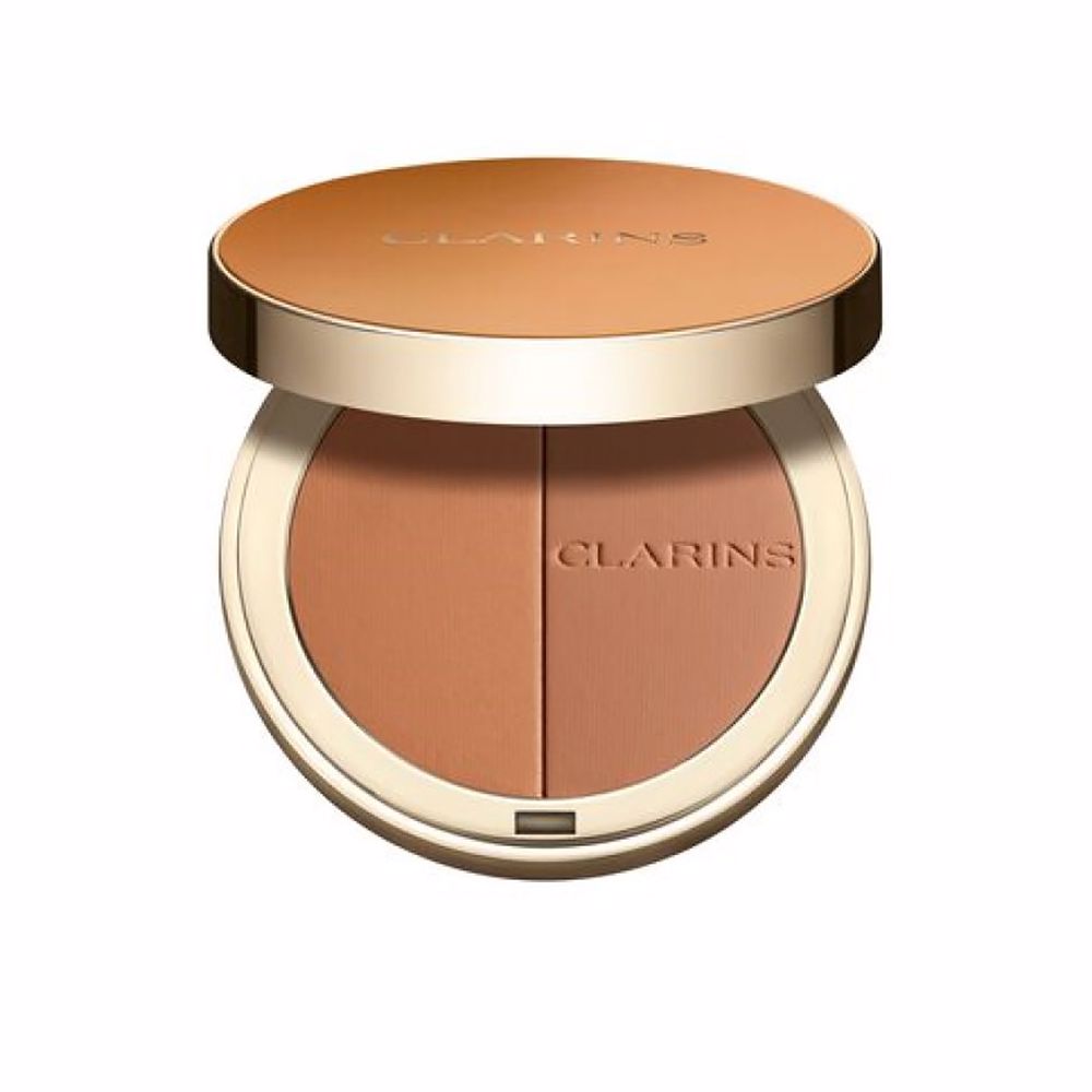 Clarins Round orange compact powder case with metallic rim, embossed brand name, minimalist metal/plastic finish