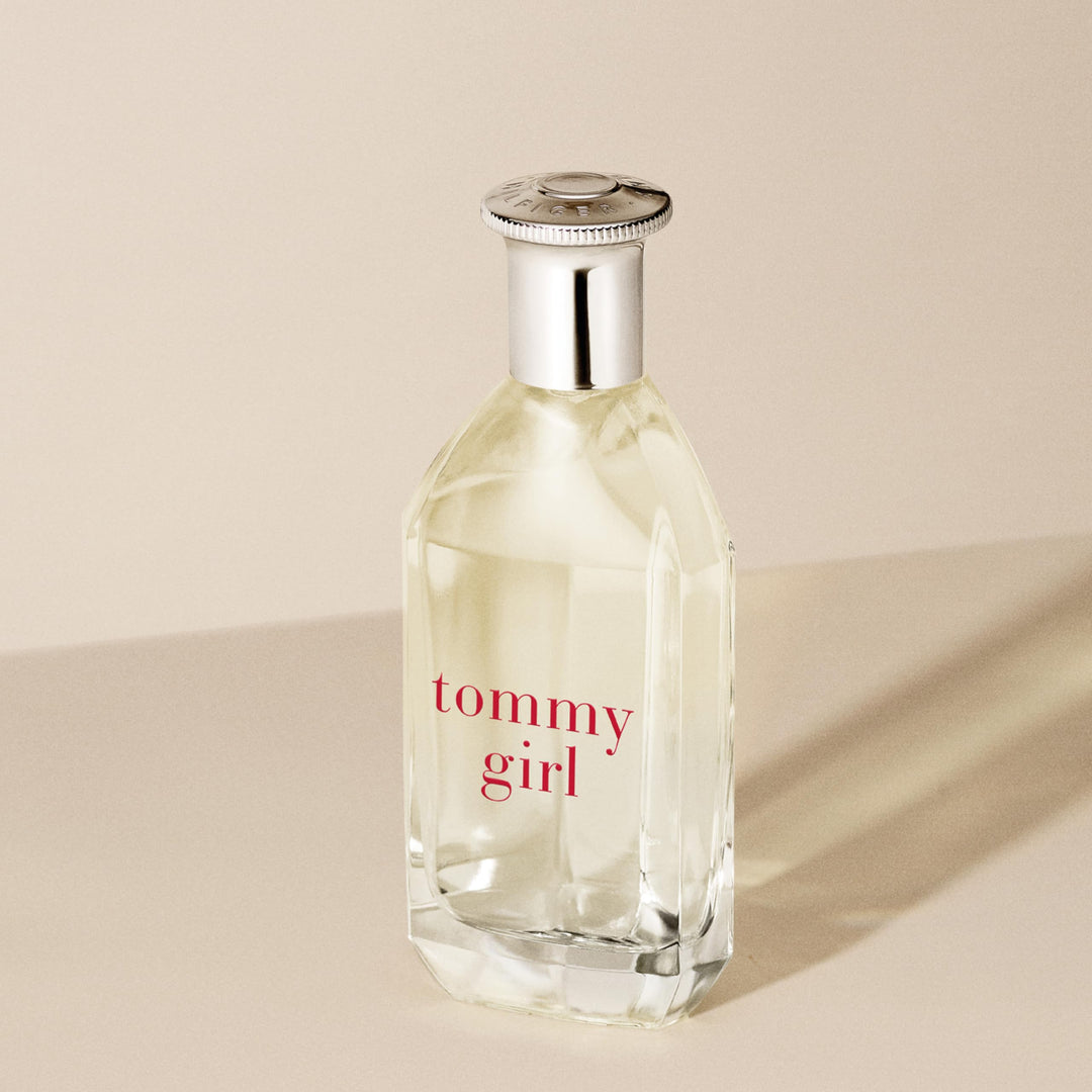 Clear curved 100 ml perfume bottle with silver cap, floral-woody scent for Women