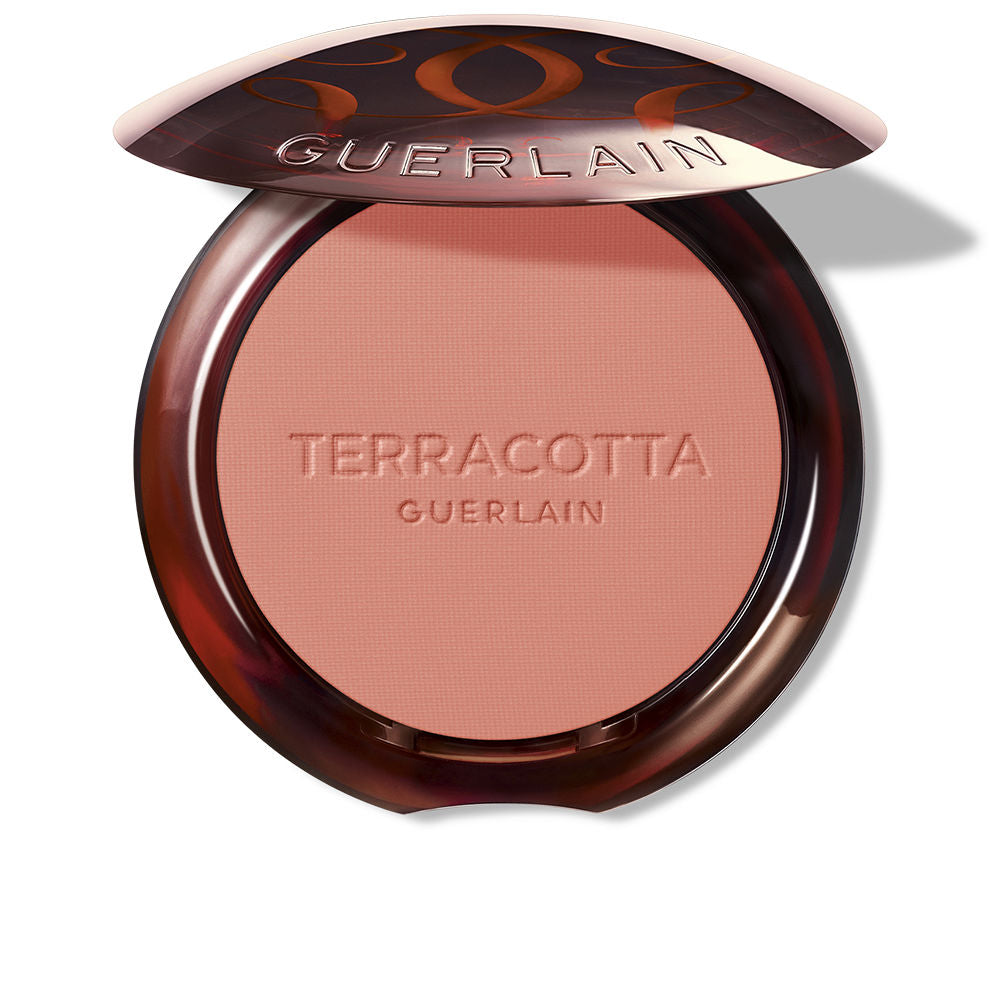 Guerlain Round glossy-lidded plastic compact showing pressed pink and brown powder blush, refined craftsmanship .