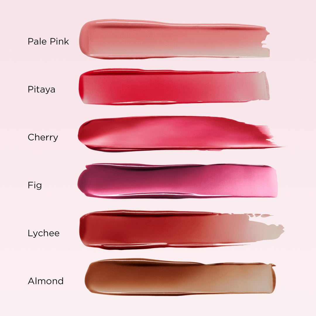 Clarins pink-and-gold twist-up lip oil balm with transparent cap, angled tip, and gold metallic base