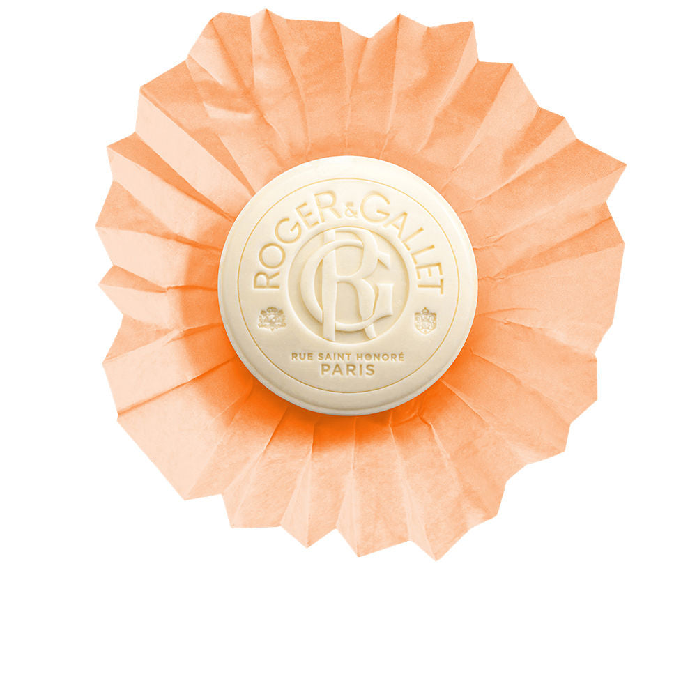 Roger & Gallet Cream and peach round bar soap with embossed logo, pleated paper wrapper, classic timeless finish .