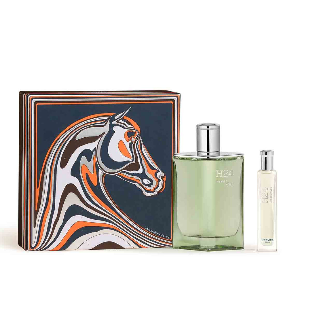 Green lacquer refillable Hermès H24 Herbes Vives perfume bottle against muted background
