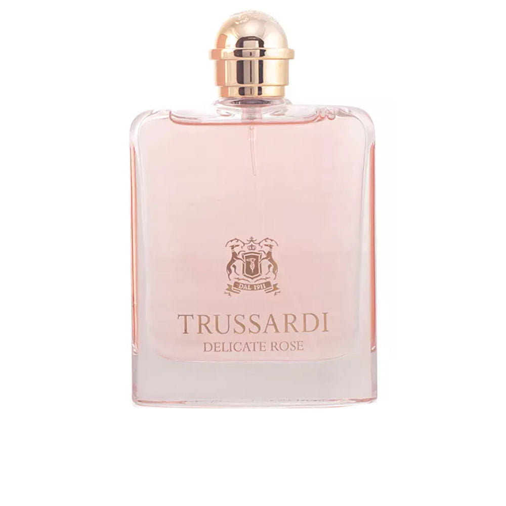 Trussardi Light pink transparent glass perfume bottle, rectangular shape with rounded gold cap, printed logo