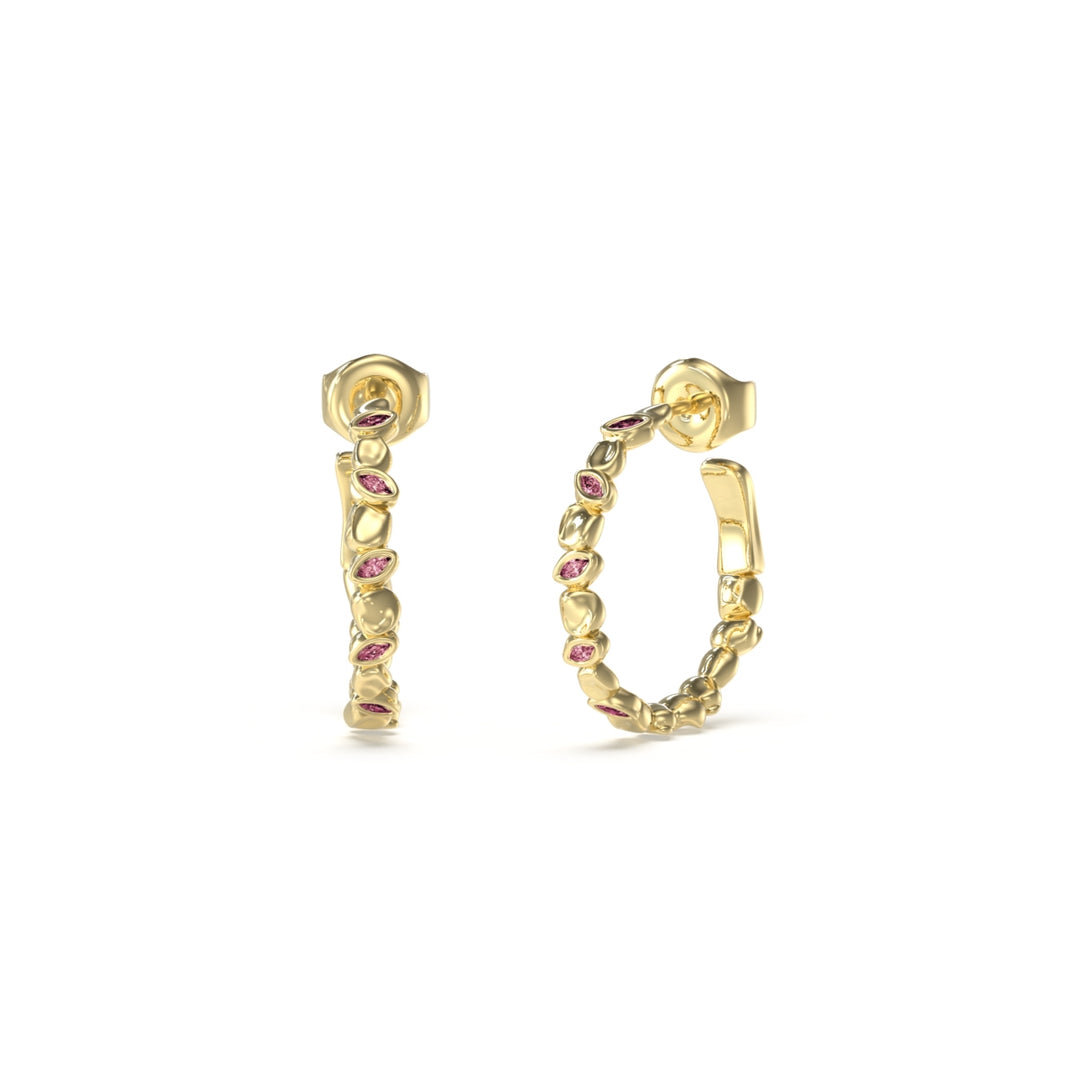 Gold textured hoop earrings set with small pink stones, decorative surface visible, secure clasp