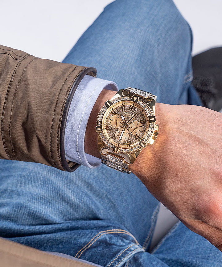 Unisex gold-tone chronograph watch with crystal-studded bezel and bracelet links on neutral background