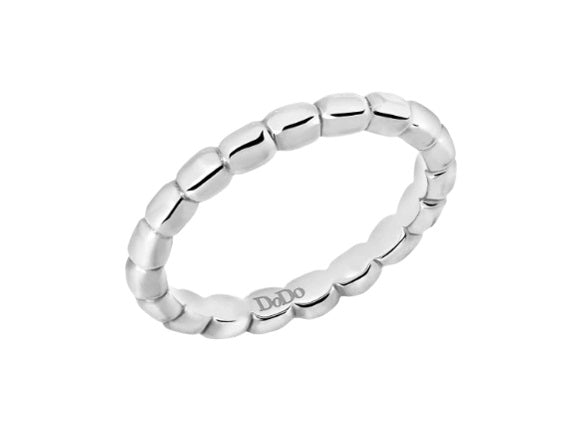 Minimalist silver beaded ring on neutral background showing repeating beaded texture and polished finish