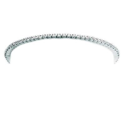 Silver tennis bracelet with small round gemstones on a thin curved band, close-up on wrist